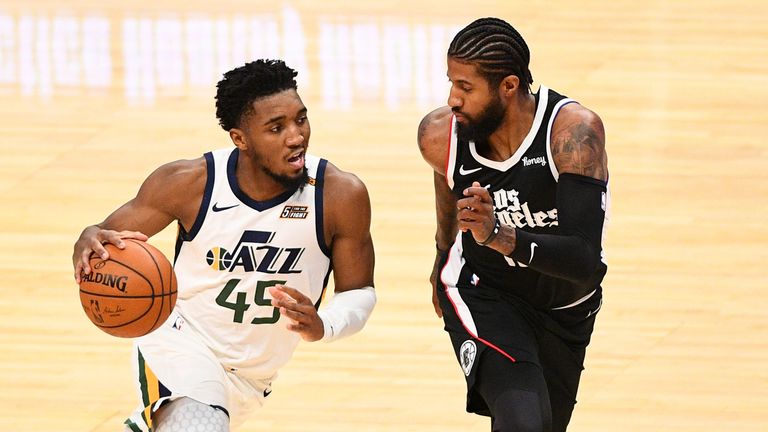 Utah Jazz Guard Donovan Mitchell is guarded closely by Los Angeles Clippers Guard Paul George