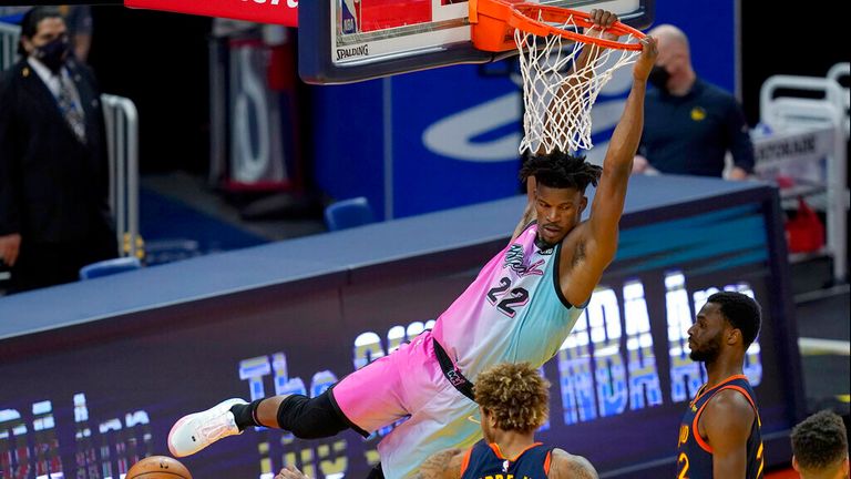 AP - Miami Heat forward Jimmy Butler, top, dunks against the Golden State Warriors