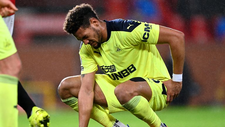 Joelinton goes down holding his hip and was withdrawn at Old Trafford