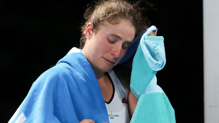 Britain's Johanna Konta reacts as she walks from the court after she retired from her first round match against Slovenia's Kaja Juvan at the Australian Open tennis championship in Melbourne, Australia, Tuesday, Feb. 9, 2021.(AP Photo/Hamish Blair)
