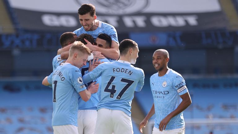 John Stones is mobbed by teammates after putting Man City back in front (AP)