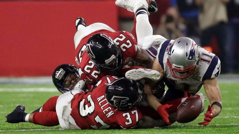 AP - New England Patriots&#39; Julian Edelman makes a catch as Atlanta Falcons&#39; Ricardo Allen and Keanu Neal defend