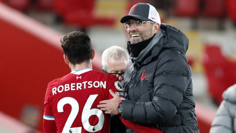 Jugen Klopp embraces Andrew Robertson at Anfield