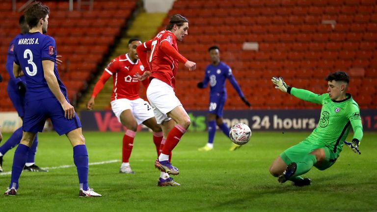 Barnsley's Callum Brittain sees his shot saved by Chelsea goalkeeper Kepa Arrizabalaga