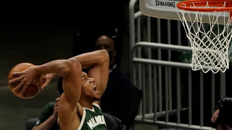 Milwaukee Bucks' Giannis Antetokounmpo goes up for a dunk during the first half of an NBA basketball game against the Sacramento Kings