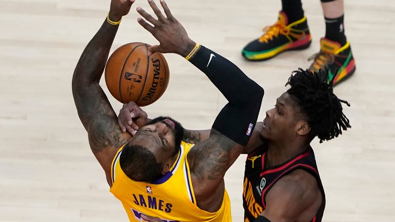 Los Angeles Lakers forward LeBron James (23) is fouled by Atlanta Hawks guard Cam Reddish (22) in the first half of an NBA basketball game, Monday, Feb. 1, 2021, in Atlanta.