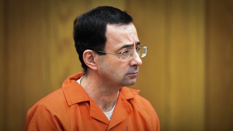 FILE - In this Feb. 5, 2018 file photo, Larry Nassar, former sports doctor who admitted molesting some of the nation's top gymnasts, appears in Eaton County Court in Charlotte, Mich. Numerous people have been criminally charged, fired or forced out of jobs in the wake of the scandal involving once-renowned gymnastics doctor, Nassar, who is serving decades in prison for molesting athletes and for child pornography crimes. (Matthew Dae Smith/Lansing State Journal via AP, File)