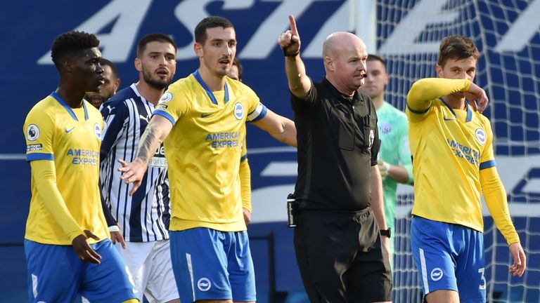Referee Lee Mason appears to award Brighton a goal that was initially disallowed