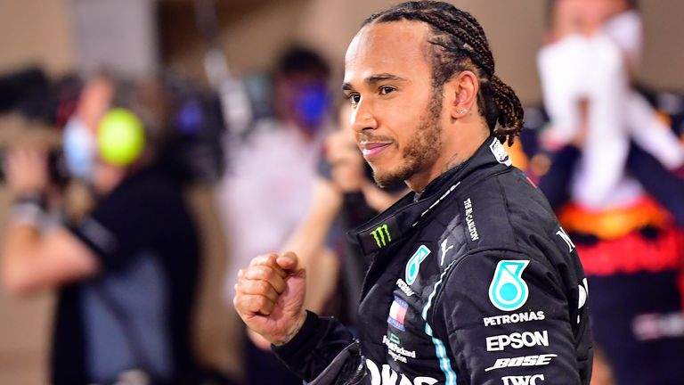 In this Sunday, Nov. 29, 2020 file photo, Mercedes driver Lewis Hamilton of Britain celebrates after wining the Formula One race in Bahrain International Circuit in Sakhir, Bahrain. The awards also recognize British performers, politicians and public servants, as well as people outside the limelight who have worked to defeat the coronavirus an
