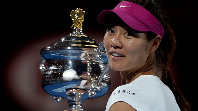 Li Na, of China, holds the championship trophy after defeating Dominika Cibulkova of Slovakia in their women&#39;s singles final at the Australian Open tennis championship in Melbourne, Australia.