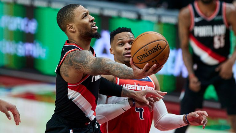 Portland Trail Blazers guard Damian Lillard shoots next to Washington Wizards guard Russell Westbrook