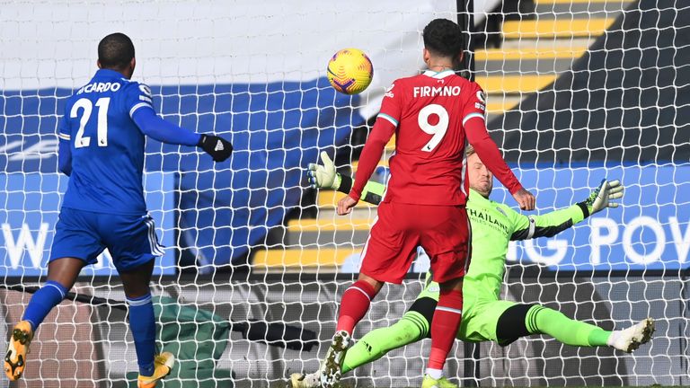 Kasper Schmeichel saves from Roberto Firmino during the first half