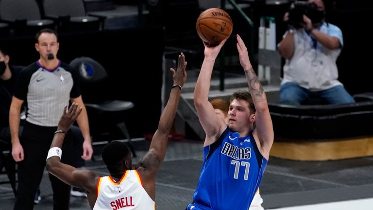 Atlanta Hawks&#39; Tony Snell defends as Dallas Mavericks&#39; Luka Doncic goes up to sink