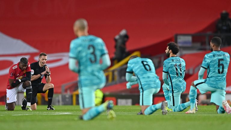 Manchester United and Liverpool players take the knee