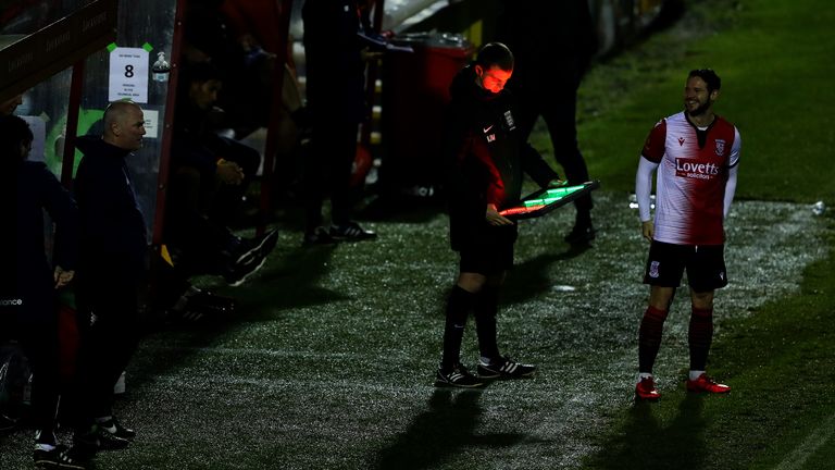Matt Jarvis of Woking FC awaits for the assistant referee makes changes to the board to enter the field as a substitute during the Vanarama National League match between Woking and Dagenham and Redbridge at Kingfield Stadium on October 13, 2020 in Woking, England.