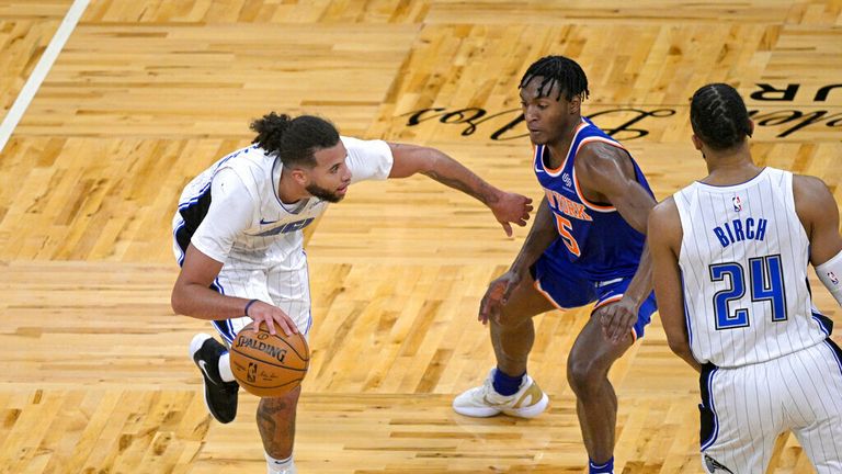 AP - Orlando Magic guard Michael Carter-Williams, left, drives past New York Knicks