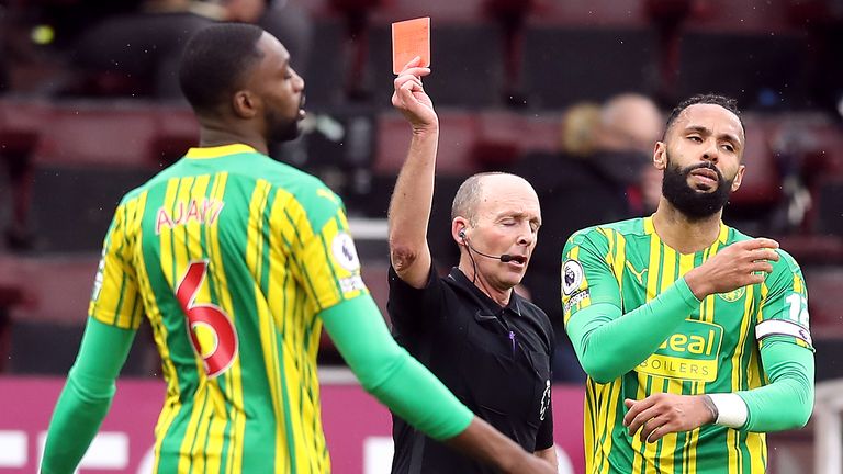 Mike Dean shows a red card to Semi Ajayi 