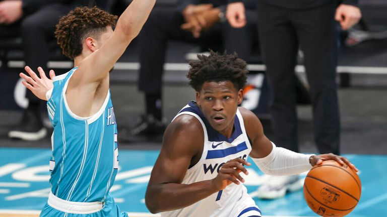 AP - Minnesota Timberwolves forward Anthony Edwards, right, drives past Charlotte Hornets guard LaMelo Ball