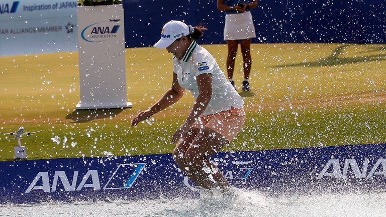 Mirim Lee of South Korea, jumps into the water after winning the LPGA's ANA Inspiration golf tournament at Mission Hills Country Club