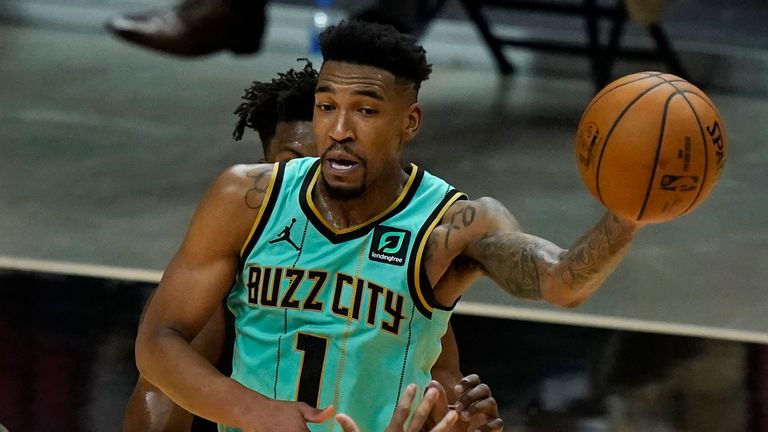 Charlotte Hornets guard Malik Monk (1) passes as Miami Heat forward Andre Iguodala (28) defends during overtime in an NBA basketball game, Monday, Feb. 1, 2021, in Miami. The Hornets won 129-121. 