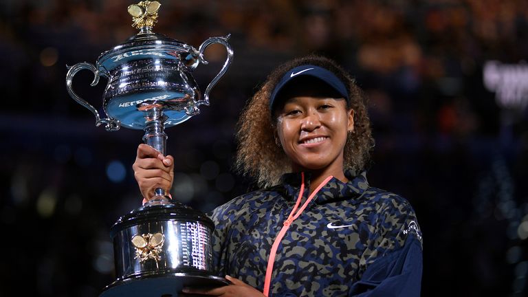 Japan's Naomi Osaka holds the Daphne Akhurst Memorial Cup aloft after defeating United States Jennifer Brady in the women's singles final at the Australian Open tennis championship in Melbourne, Australia, Saturday, Feb. 20, 2021.(AP Photo/Andy Brownbill)