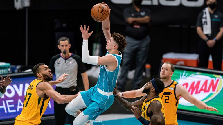 Charlotte Hornets guard LaMelo Ball (2) drives to the basket while guarded by Utah Jazz center Rudy Gobert (27) during the second half of an NBA basketball game in Charlotte, N.C., Friday, Feb. 5, 2021. (AP Photo/Jacob Kupferman)


