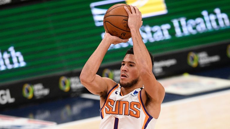 Phoenix Suns guard Devin Booker (1) shoots during the first half of an NBA basketball game against the Washington Wizards, Monday, Jan. 11, 2021, in Washington.