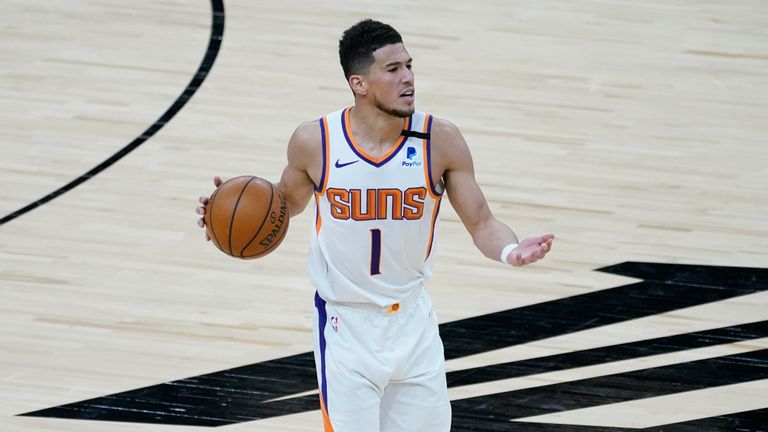 Phoenix Suns guard Devin Booker (1) looks to pass against the Cleveland Cavaliers during the second half of an NBA basketball game, Monday, Feb. 8, 2021, in Phoenix. (AP Photo/Matt York)


