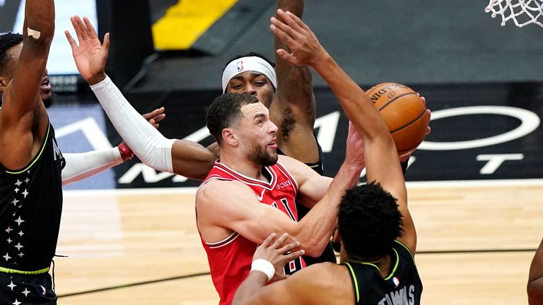 Chicago Bulls guard Zach LaVine, center, drives to the basket against Minnesota Timberwolves' Malik Beasley, left, Jarred Vanderbilt, and Karl-Anthony Towns, right, during the first half of an NBA basketball game in Chicago, Wednesday, Feb. 24, 2021. (AP Photo/Nam Y. Huh)


