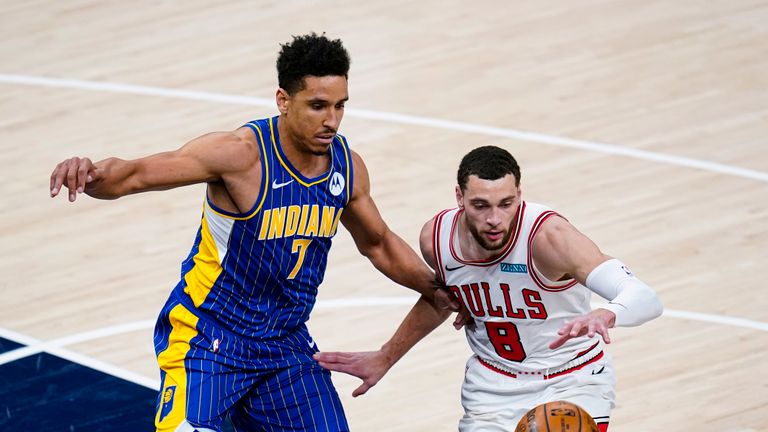 Indiana Pacers guard Malcolm Brogdon (7) defends Chicago Bulls guard Zach LaVine (8) during the first half of an NBA basketball game in Indianapolis, Monday, Feb. 15, 2021. (AP Photo/Michael Conroy)


