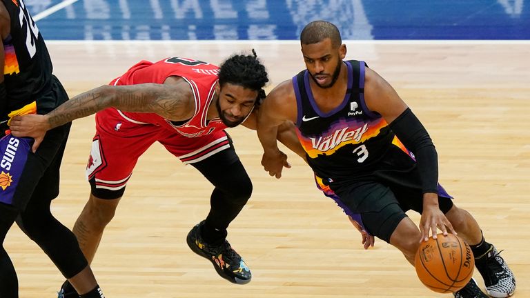 Phoenix Suns guard Chris Paul, right, drives against Chicago Bulls guard Coby White during the first half of an NBA basketball game in Chicago, Friday, Feb. 26, 2021. (AP Photo/Nam Y. Huh)


