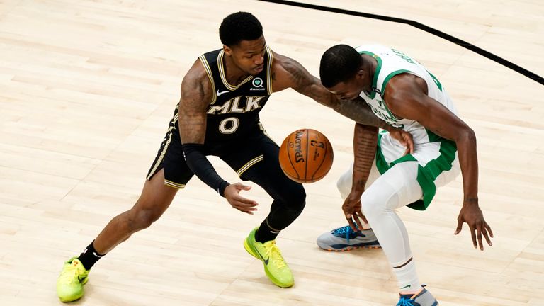 Atlanta Hawks guard Brandon Goodwin (0) comes up with a loose ball against Boston Celtics guard Javonte Green (43) In the second half of an NBA basketball game Wednesday, Feb. 24, 2021, in Atlanta. (AP Photo/John Bazemore)


