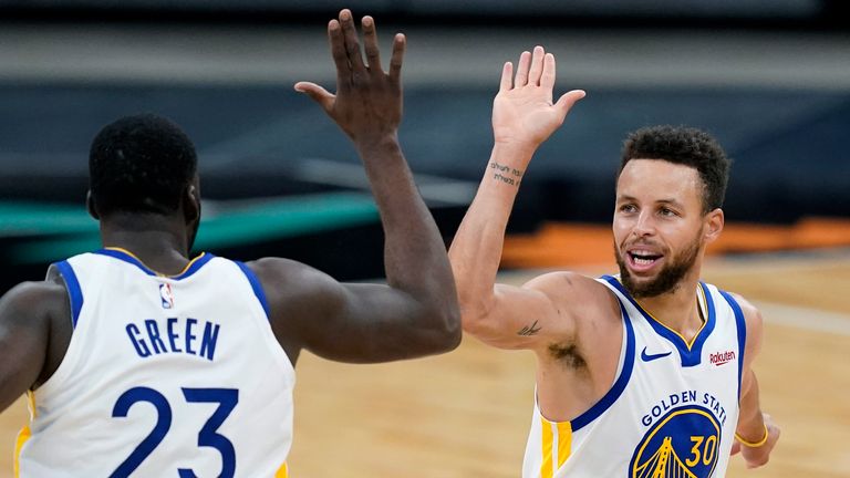 Golden State Warriors guard Stephen Curry (30) celebrates a score with teammate Draymond Green (23) during the second half of an NBA basketball game against the San Antonio Spurs in San Antonio, Tuesday, Feb. 9, 2021.