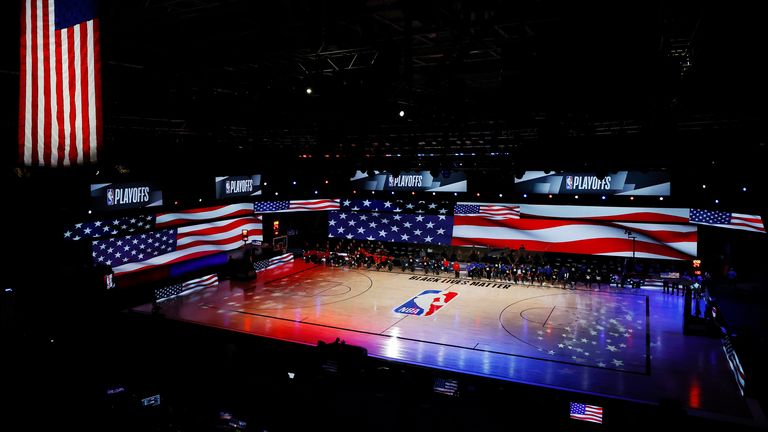 Players take a knee during the national anthem before a game between the LA Clippers and the Dallas Mavericks in Game One of the Western Conference First Round during the 2020 NBA Playoffs