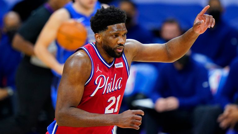 Philadelphia 76ers' Joel Embiid, right, reacts after a dunk during the first half of an NBA basketball game against the Dallas Mavericks, Thursday, Feb. 25, 2021, in Philadelphia.