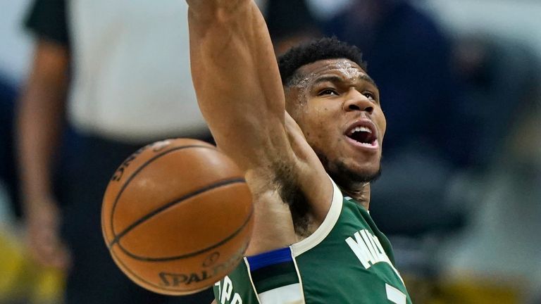Milwaukee Bucks&#39; Giannis Antetokounmpo dunks the ball in the first half of an NBA basketball game against the Cleveland Cavaliers, Saturday, Feb. 6, 2021, in Cleveland. (AP Photo/Tony Dejak)


