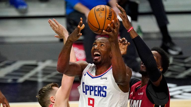 Los Angeles Clippers center Serge Ibaka, center, shoots as Miami Heat guard Duncan Robinson, left, and center Bam Adebayo defend during the first half of an NBA basketball game Monday, Feb. 15, 2021, in Los Angeles. (AP Photo/Mark J. Terrill)


