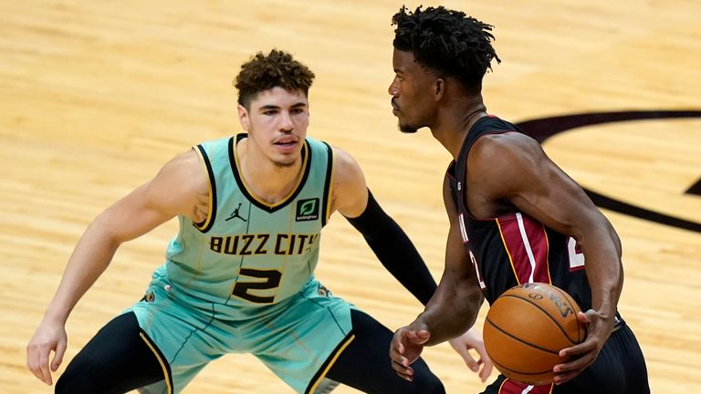 Charlotte Hornets guard LaMelo Ball (2) defends Miami Heat forward Jimmy Butler, right, during the first half of an NBA basketball game, Monday, Feb. 1, 2021, in Miami. 