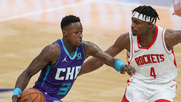 Charlotte Hornets guard Terry Rozier, left, brings the ball up court against Houston Rockets forward Danuel House Jr. (4) in the second half of an NBA basketball game in Charlotte, N.C., Monday, Feb. 8, 2021. (AP Photo/Nell Redmond)


