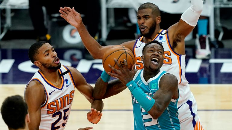 Charlotte Hornets guard Terry Rozier (3) drives past Phoenix Suns forward Mikal Bridges (25) during the first half of an NBA basketball game, Wednesday, Feb. 24, 2021, in Phoenix. (AP Photo/Matt York)


