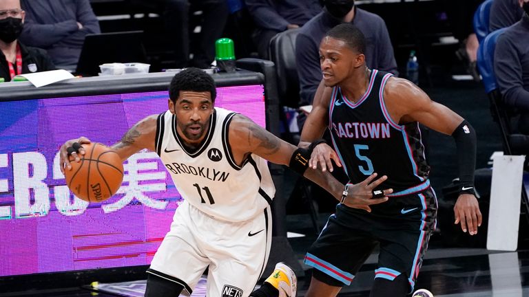 Brooklyn Nets guard Kyrie Irving, left, drives downcourt against Sacramento Kings guard De&#39;Aaron Fox during the first half of an NBA basketball game in Sacramento, Calif., Monday, Feb. 15, 2021. (AP Photo/Rich Pedroncelli)


