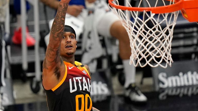 Utah Jazz guard Jordan Clarkson (00) scores against Philadelphia 76ers center Dwight Howard in the second half during an NBA basketball game Monday, Feb. 15, 2021, in Salt Lake City. (AP Photo/Rick Bowmer)



