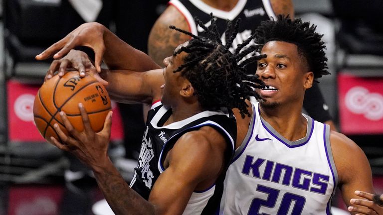 Los Angeles Clippers guard Terance Mann, left, grabs a rebound away from Sacramento Kings center Hassan Whiteside during the second half of an NBA basketball game Sunday, Feb. 7, 2021, in Los Angeles. (AP Photo/Mark J. Terrill)


