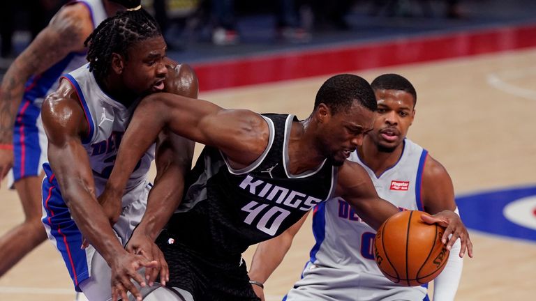 Sacramento Kings forward Harrison Barnes (40) is fouled by Detroit Pistons center Isaiah Stewart, left, next to Detroit Pistons guard Dennis Smith Jr. (0) during the first half of an NBA basketball game, Friday, Feb. 26, 2021, in Detroit. (AP Photo/Carlos Osorio)


