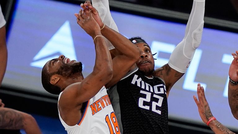 New York Knicks guard Alec Burks (18) is fouled by Sacramento Kings center Richaun Holmes (22) during the first half of an NBA basketball game Thursday, Feb. 25, 2021, in New York.