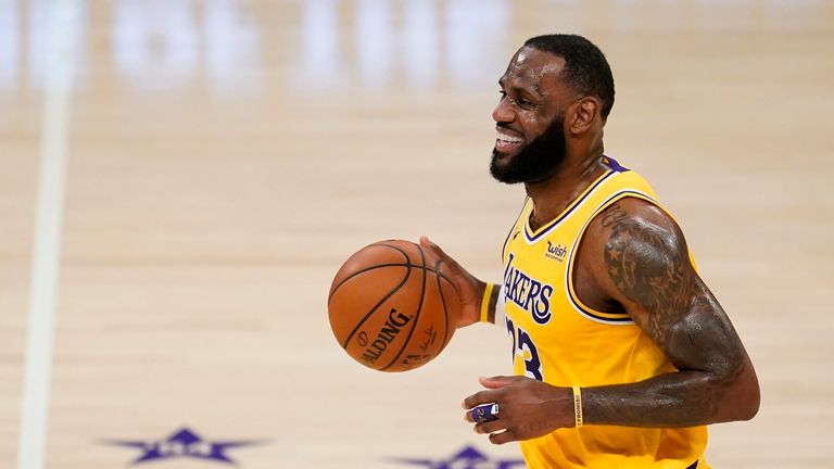 Los Angeles Lakers forward LeBron James smiles as he dribbles the ball during the first half of the team&#39;s NBA basketball game against the Detroit Pistons on Saturday, Feb. 6, 2021, in Los Angeles. (AP Photo/Marcio Jose Sanchez)


