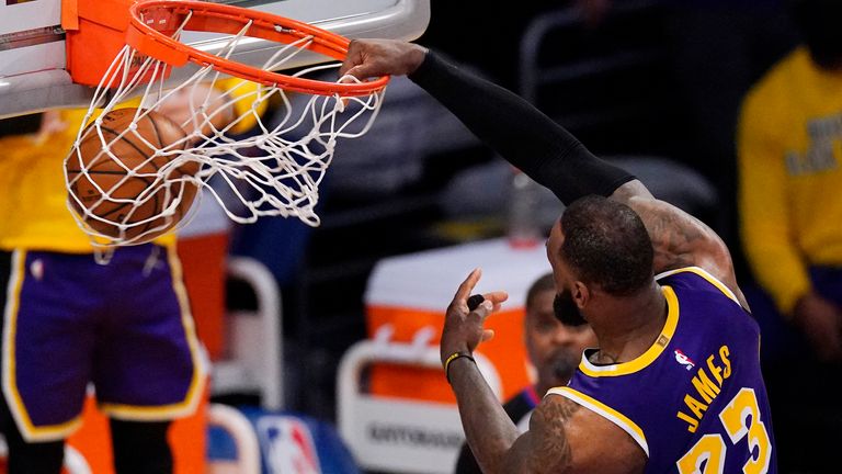 Los Angeles Lakers forward LeBron James dunks during the second half of the team's NBA basketball game against the Memphis Grizzlies on Friday, Feb. 12, 2021, in Los Angeles. The Lakers won 115-105.