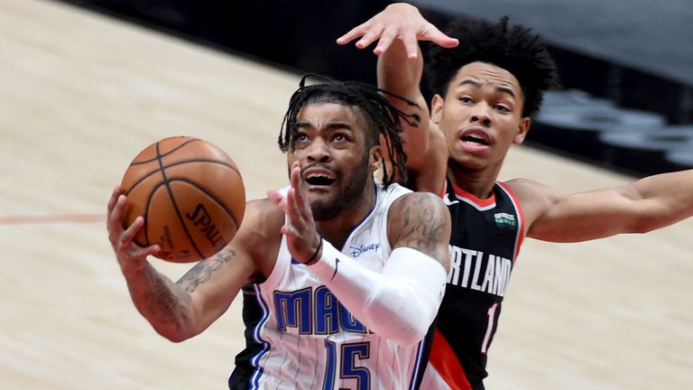 Orlando Magic guard Frank Mason III, left, drives to the basket on Portland Trail Blazers guard Anfernee Simons, right, during the first half of an NBA basketball game in Portland, Ore., Tuesday, Feb. 9, 2021.