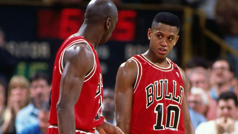 Michael Jordan and BJ Armstrong of the Chicago Bulls talk during a game against the Boston Celtics circa 1991 at the Boston Garden