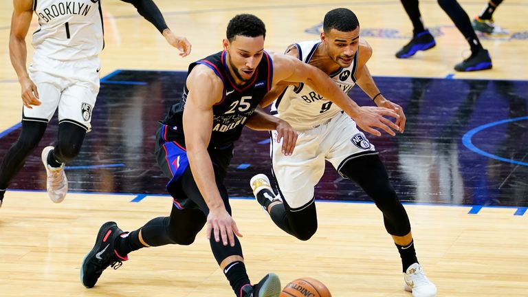 Philadelphia 76ers&#39; Ben Simmons, left, and Brooklyn Nets&#39; Timothe Luwawu-Cabarrot chase down a loose ball during the second half of an NBA basketball game, Saturday, Feb. 6, 2021, in Philadelphia. (AP Photo/Matt Slocum)


